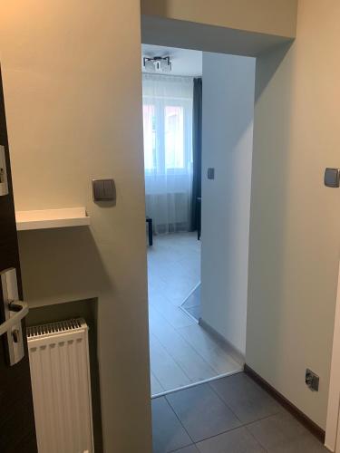 an open door to a room with a hallway at Nad rzeką in Piła