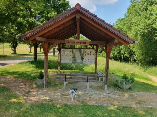 a gazebo with a dog standing in front of it at Ferienwohnung Auszeit in Niederviehbach