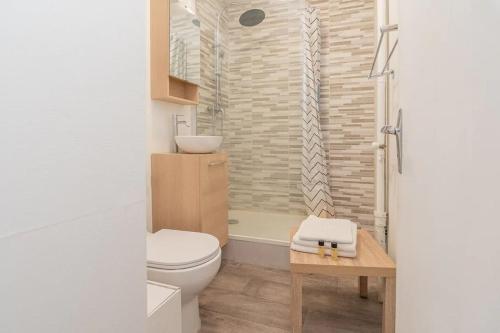 a bathroom with a toilet and a sink at Le charme Chalonnais in Chalon-sur-Saône