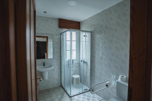 a bathroom with a shower and a sink at Apartamentos Coral Do Mar I in Portonovo