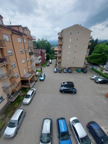 a group of cars parked in a parking lot at Apartmani Bojković in Vrnjačka Banja