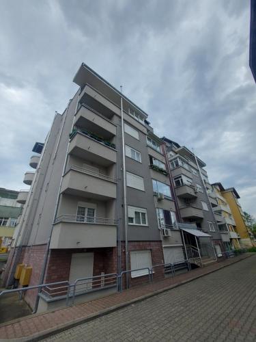 a large apartment building on the side of a street at Apartmani Bojković in Vrnjačka Banja