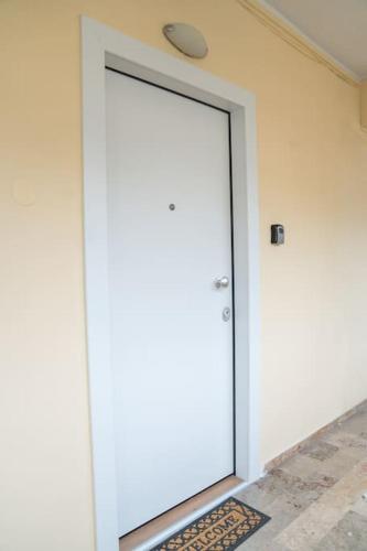 a large white door in a room with a rug at Kozani Residence 1 in Kozani