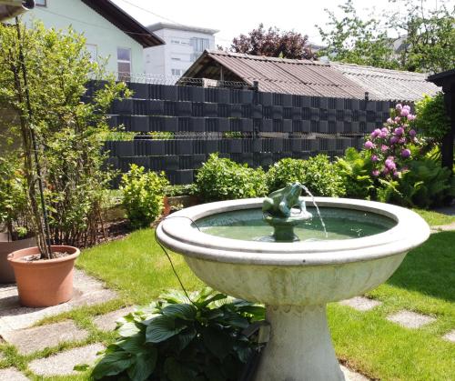 a bird bath in a yard with a fountain at Apartment Sonata in Kamnik