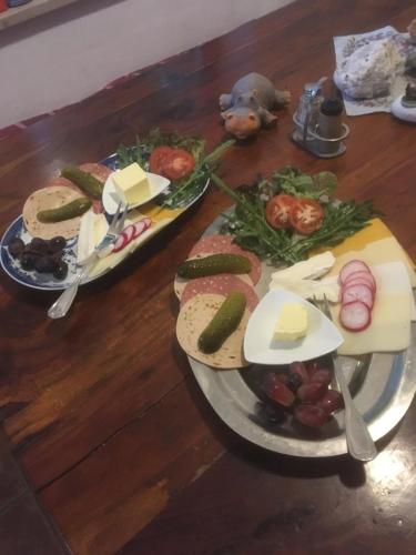 a wooden table with two plates of food on it at Pension Zur Freiheit in Passau