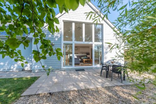a patio with a table and chairs in front of a house at Seashells in Woolacombe