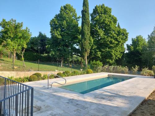 a swimming pool in a yard with trees at Anima Franca Bed and breakfast in Greve in Chianti