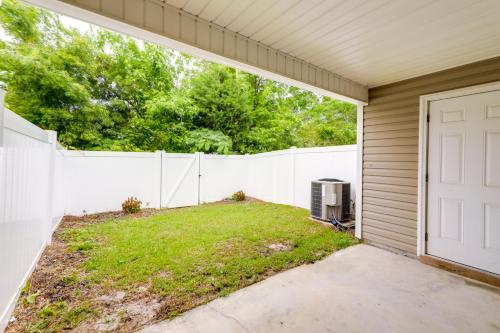 an exterior view of a backyard with a white fence at Havelock Home Private Yard, 2 Mi to Cherry Point! in Havelock
