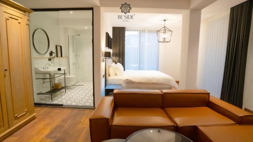 a living room with a couch and a bed and a bathroom at Be Side Hotel in Samsun