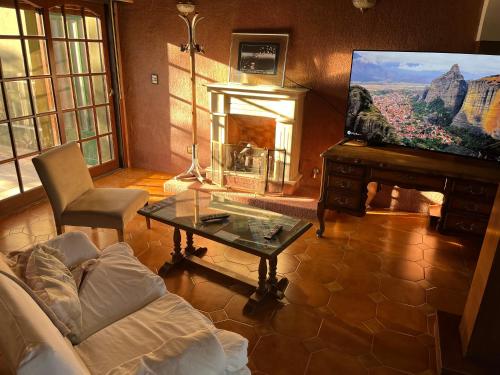 a living room with a couch and a table and a piano at SWEET HOME PATAGONIA in Comodoro Rivadavia