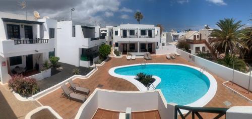 an aerial view of a house with a swimming pool at Apartamentos Albatros in Puerto del Carmen