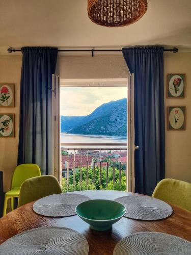 a dining room table with a view of the ocean at Apartment Mint&Rose in Risan