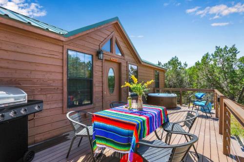 a table and chairs on a deck with a grill at Terlingua at the Bend in Wimberley