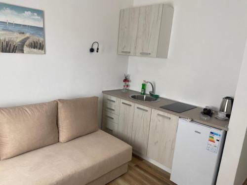 a living room with a couch and a kitchen at Xhan Apartments in Ulcinj