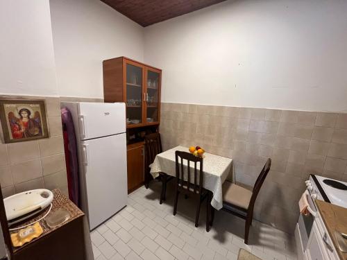 a small kitchen with a table and a refrigerator at Korra in Herceg-Novi
