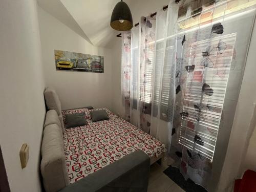 a small room with a bed in the corner at Korra in Herceg-Novi