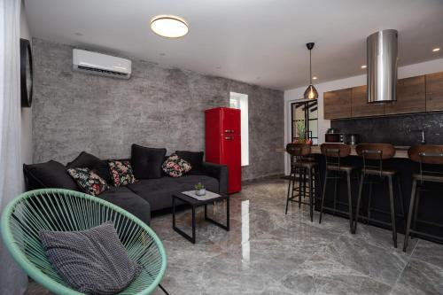 a living room with a couch and a bar at Luxury Apartman Tinel in Mimice