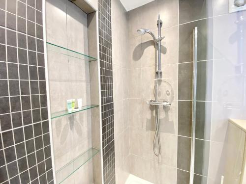 a bathroom with a shower with a glass door at 3 Queen Alexandra Road in North Shields