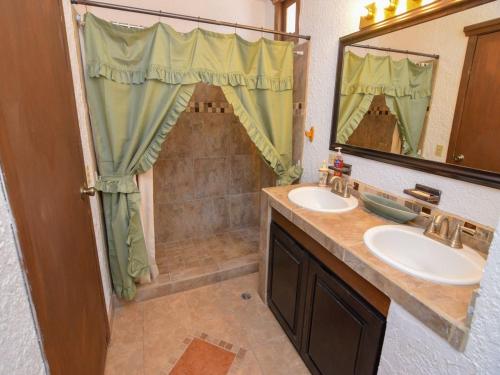 a bathroom with two sinks and a large mirror at La Hacienda San Felipe Condo 10 in San Felipe