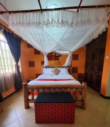 a bedroom with a bed with a canopy at Edaala Comfort - B&B in Nairobi