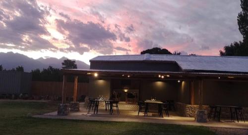 a building with a table and chairs in a yard at CARASUR in Vista Flores