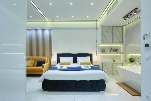 a bedroom with a king sized bed and a tub and a sink at RINO LUXURY ROOM in Zadar
