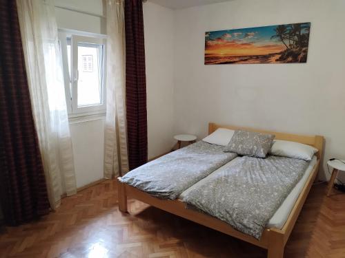a bedroom with a bed and a window at Stonewood Dalmacija in Primošten