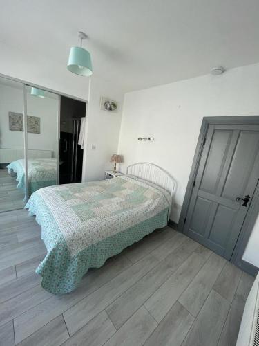 a bedroom with a bed and a mirror at The Bungalow Castlepollard in Westmeath