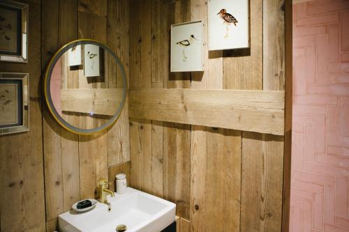 a bathroom with a sink and a mirror at Wellies & Waves in Kingsbridge