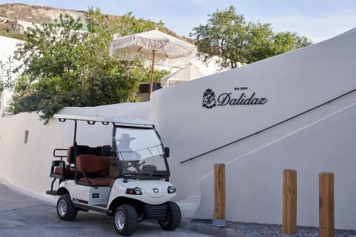 a golf cart parked next to a white building at Maison Dalidaz in Vóthon