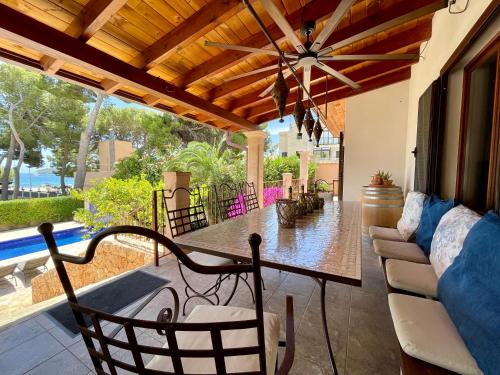 a patio with a table and chairs and a couch at Villa Buena Vista in Palmanova