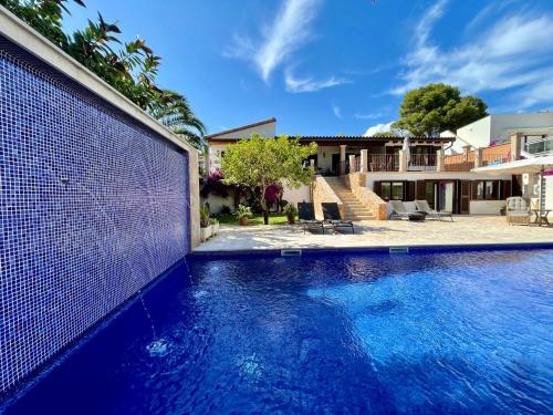a swimming pool in front of a house at Villa Buena Vista in Palmanova