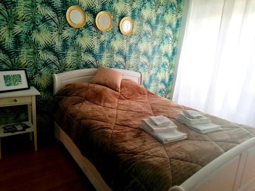 - une chambre avec un lit et 3 miroirs sur le mur dans l'établissement Cocoon Guest House Vendas Novas, à Vendas Novas