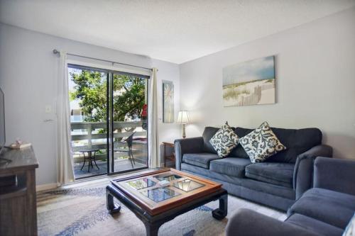 a living room with a couch and a coffee table at 5 stars Peaceful Condo - 7 min walk to the beach in Hilton Head Island