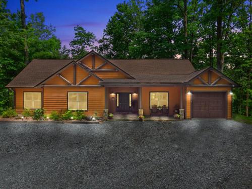 a house with a car garage in a driveway at Stunning Views, Superb Atmosphere, Modern Amenities, In the Middle of Nature in Bryson City