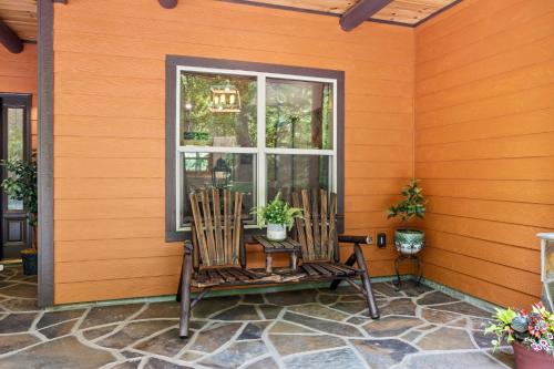 a porch with two rocking chairs in front of a window at Stunning Views, Superb Atmosphere, Modern Amenities, In the Middle of Nature in Bryson City