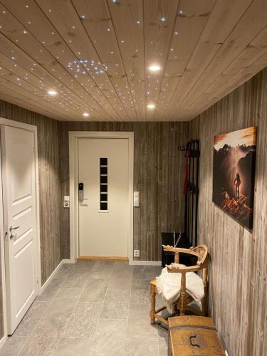 a room with a hallway with wooden walls and a door at Fjelltun Lodge in Sogndal