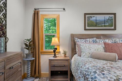 a bedroom with a bed and a window at Stunning Views, Superb Atmosphere, Modern Amenities, In the Middle of Nature in Bryson City