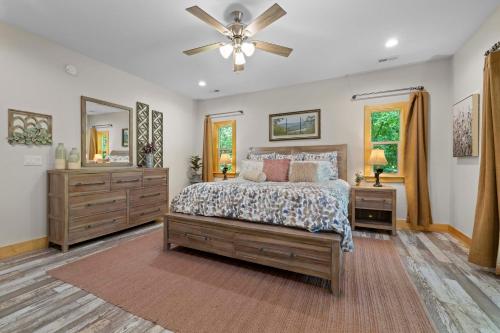 a bedroom with a bed and a ceiling fan at Stunning Views, Superb Atmosphere, Modern Amenities, In the Middle of Nature in Bryson City