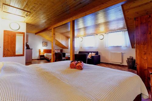 a bedroom with a large bed with two red roses on it at Penzion U TŘÍ RŮŽÍ - Adults Only in Vrbice