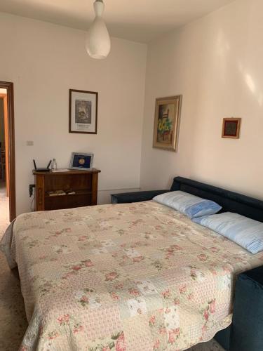 a bedroom with a large bed and a desk at La Mandola in Castiglione dʼOrcia
