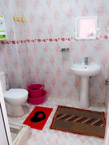 a bathroom with a toilet and a sink at Blue meadow in Moulay Bousselham