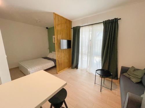 a small room with a bed and a couch and a table at Modern studio overlooking downtown in Makarska