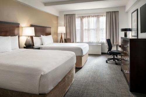 a hotel room with two beds and a desk at Residence Inn by Marriott New York Manhattan/ Midtown Eastside in New York