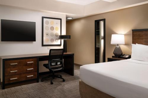 a hotel room with a bed and a desk with a computer at Residence Inn by Marriott New York Manhattan/ Midtown Eastside in New York