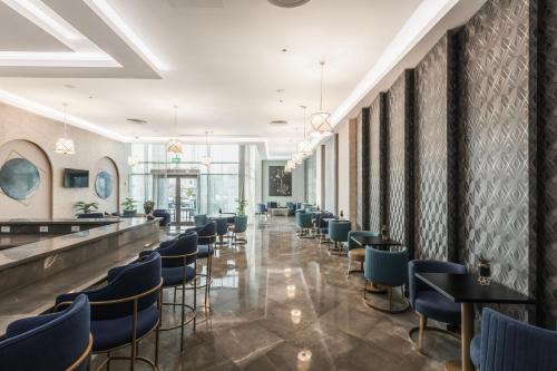 a bar with chairs and tables in a restaurant at Gewan White Beach Resort-New Alamein in Marsa Matruh