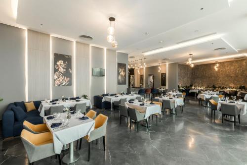 a dining room with white tables and chairs at Gewan White Beach Resort-New Alamein in Marsa Matruh
