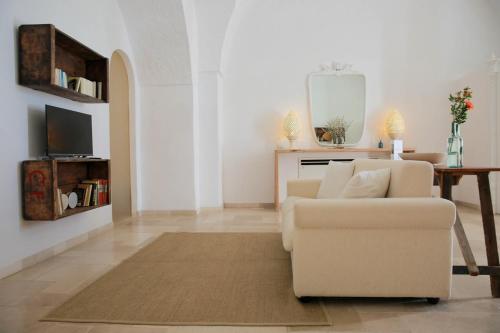 a living room with a couch and a table at Masseria Parco della Grava in Pezze di Greco