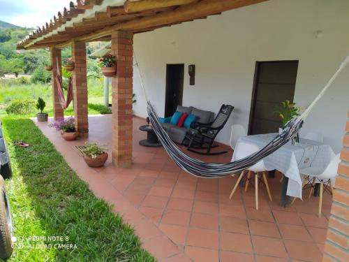 a hammock on the patio of a house at Cabaña villa lola in San Gil