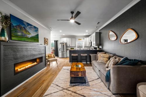 a living room with a couch and a fireplace at *Dog Friendly*Modern home-Minutes to Dollywood, Gatlinburg, Smoky Mountains & Pigeon Forge! in Pigeon Forge